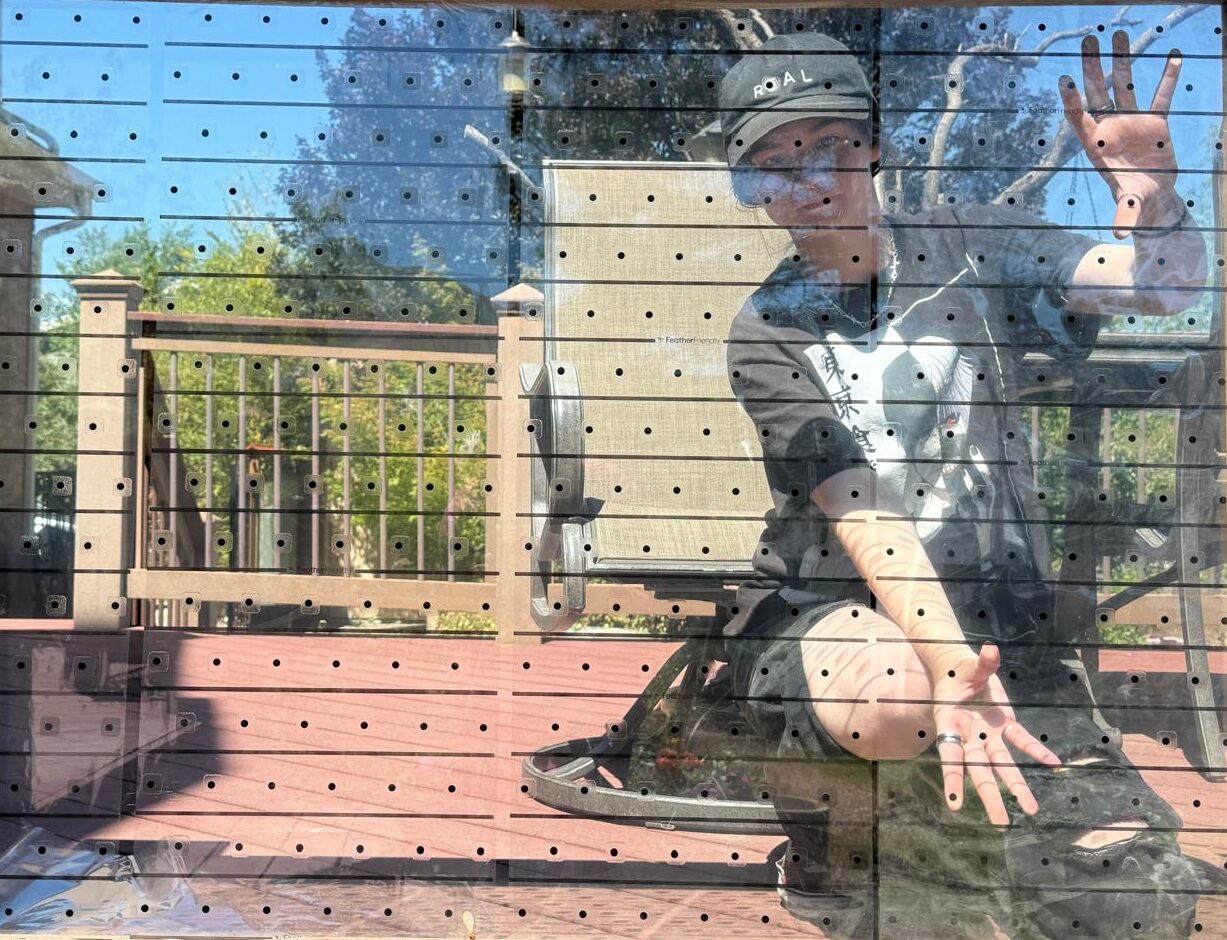 Bird Safe Windows intern installing bird-safe film on a residential window